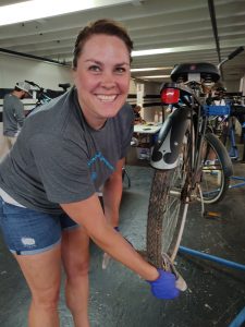 Woman cleaning a bike